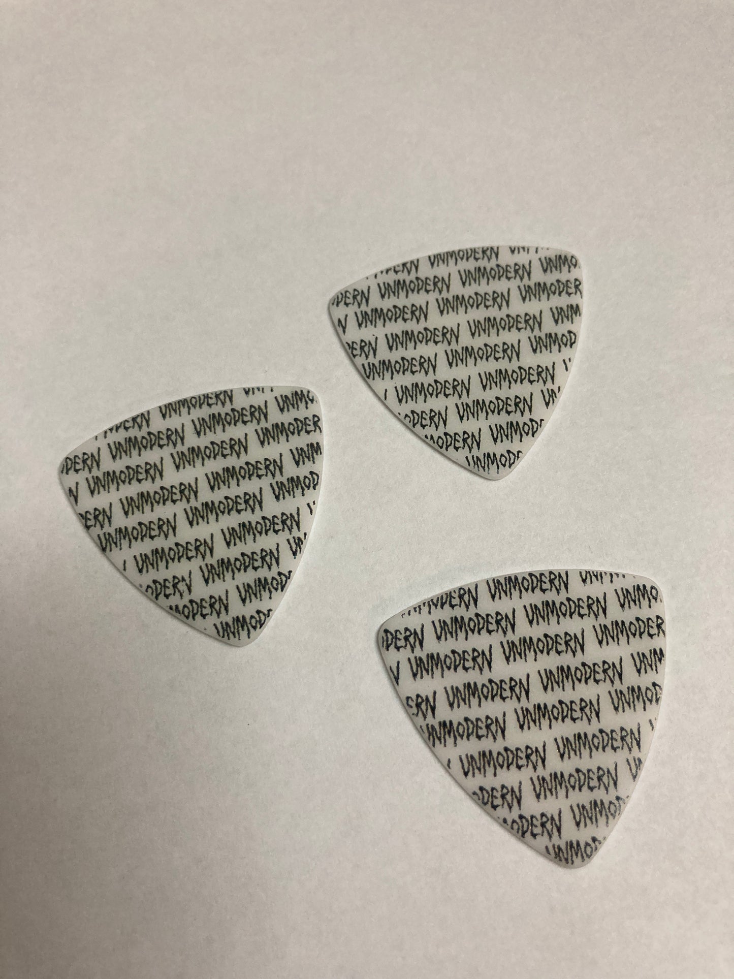 UNMODERN | Bleeding Logo Bass Guitar Picks | White- Medium/Hard | 3-Pack Set