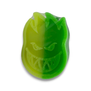 Spitfire Bighead logo skateboard curb wax in two-tone yellow and green swirl