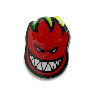 Spitfire Bighead logo swirl skate wax in red, black, green, and yellow