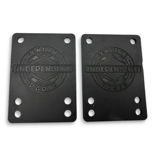 Two black Independent Genuine Parts rubber skateboard shock pads with embossed logo