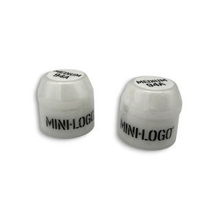 Two white Mini Logo medium 94A skateboard bushings on white background