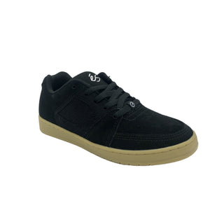 A black and gum ÉS Accel Slim skateboarding shoe with a suede upper and a logo on the heel.