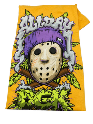 A gold-colored t-shirt with a graphic print of a character's face with a purple hat and smoke coming from it, set against a yellow background.